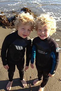 twins standing on shoreline thumbnail