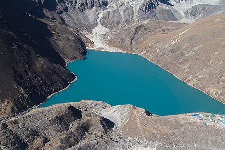 aerial photo of body of water near mountain thumbnail