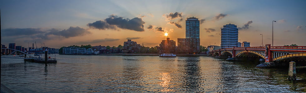 ship near on city in golden hour photography thumbnail