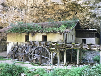 gray and black wooden house near cliff thumbnail
