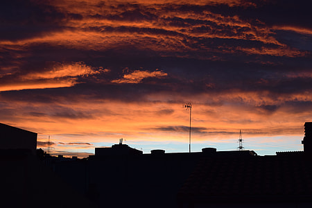 silhouette of buildings under clouds thumbnail