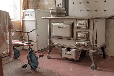 photo of white vintage cooking equipment on red concrete pavement near bike thumbnail