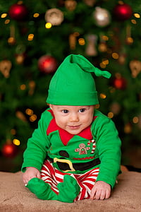 baby wearing green and red elf costume thumbnail