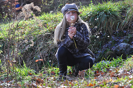 girl wearing gray long-sleeved shirt blowing the dandelion thumbnail