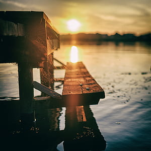 low angle photography of dock under sunrise thumbnail