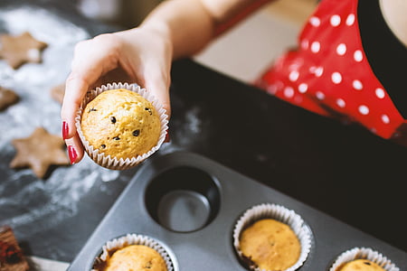 person holding baked muffin thumbnail