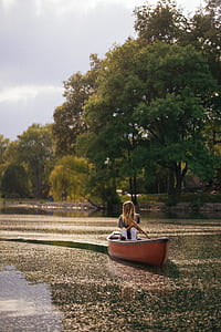woman riding on boat on calm water at daytime thumbnail