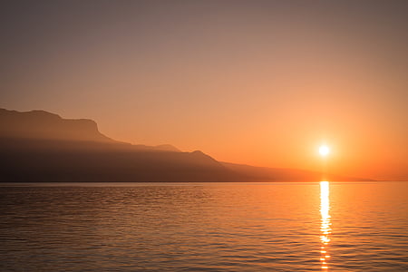 clear body of water with mountain as background thumbnail