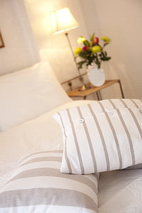 two white throw pillows on bed surface thumbnail