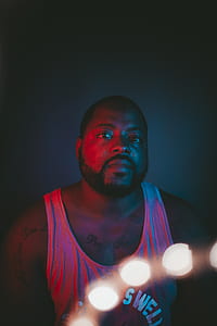 bokeh photography of man wearing tank top thumbnail