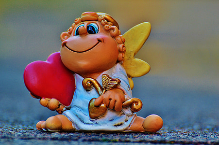 macro shot photography of cherub ceramic figurine thumbnail