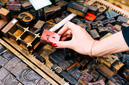 Person Holding Red Wooden Letter a Ornament thumbnail