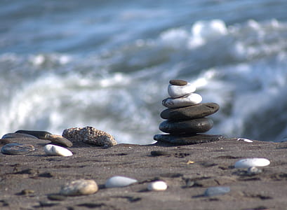 pile of stones on black sand thumbnail
