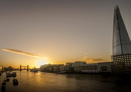 concrete building beside body of water during golden hour thumbnail