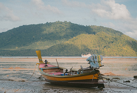 brown boat in seashore thumbnail