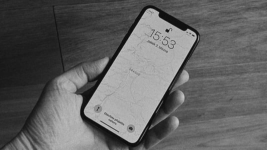 person holding turned on space gray iPhone X thumbnail