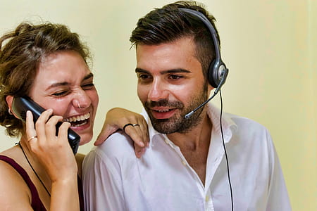 man and woman smiling near wall thumbnail