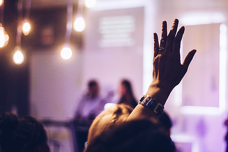 selective focus of person raising hands thumbnail
