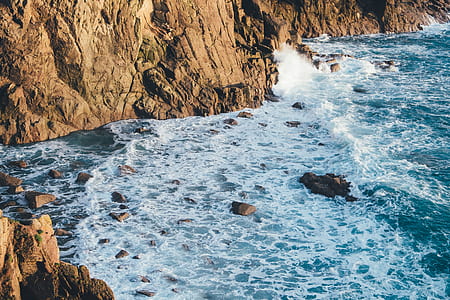 rock formation beside body of water thumbnail