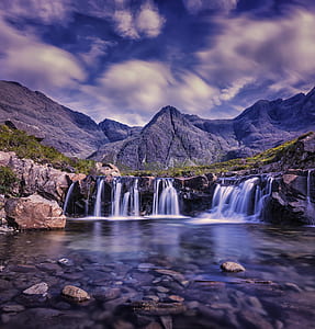 photography of waterfalls near mountains thumbnail