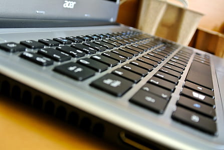 gray Acer laptop on brown wooden surface thumbnail