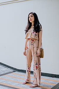 woman standing near white painted wall thumbnail