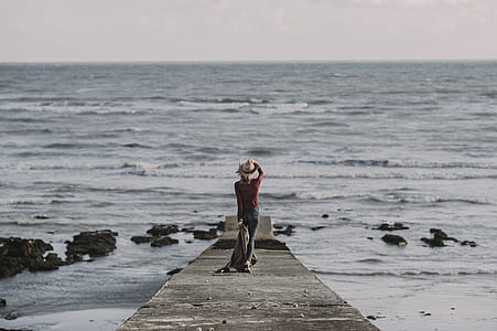 Person Standing on Dock Holding Textile thumbnail