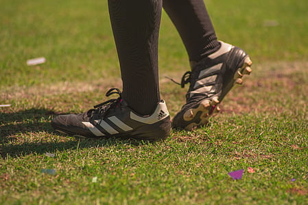 person wearing gray-and-white adidas cleats thumbnail