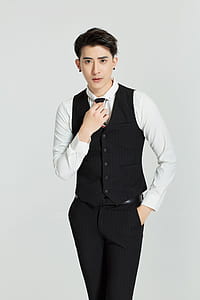 man wearing black button-up vest, white dress shirt and black dress pants outfit thumbnail