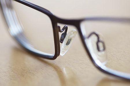gray framed eyeglasses on brown table in shallow photography during daytime thumbnail