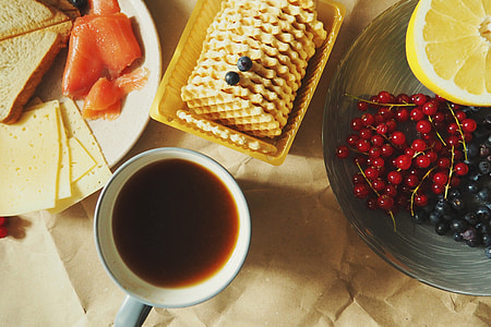 Overhead shot of coffee, biscuits, cheese and fruits thumbnail