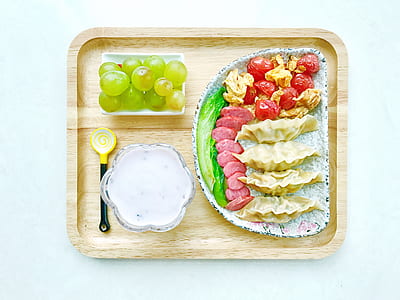 flat lay photography of dumplings on plate and on tray thumbnail