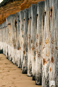 brown handprints on gray wooden logs thumbnail