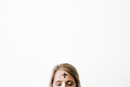 woman with black cross on forehead thumbnail