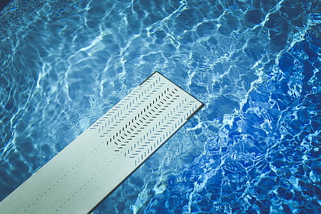 white wooden dive board near body of water thumbnail
