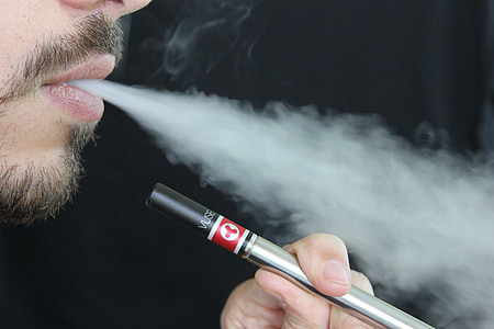 man holding gray electric cigarette thumbnail