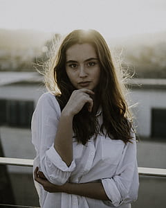 woman standing behind sunset thumbnail