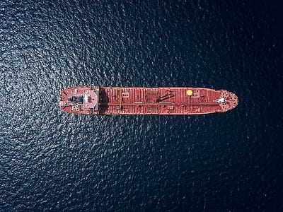 top view photo of red oil ship on water at daytime thumbnail