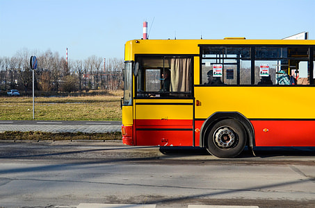 yellow and red bus parked on roadside thumbnail