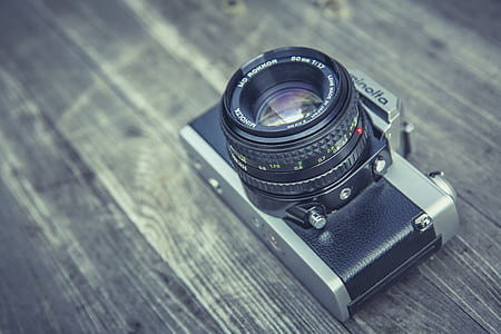 silver and black Minolta rangefinder camera on table thumbnail