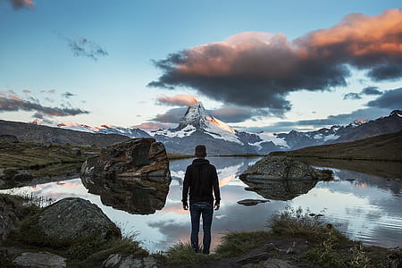 photo of man standing near body of water thumbnail