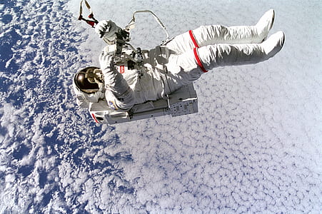 astronaut floating in space at daytime thumbnail