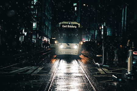 white train traveling on town thumbnail