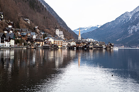 village beside large calm body of water thumbnail