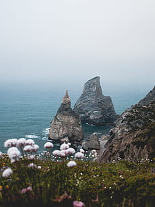 rock formation on body of water thumbnail