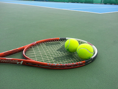 red and white tennis racket and two tennis balls thumbnail
