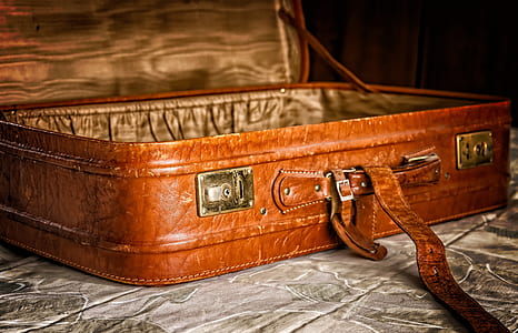brown leather suitcase on gray cloth thumbnail