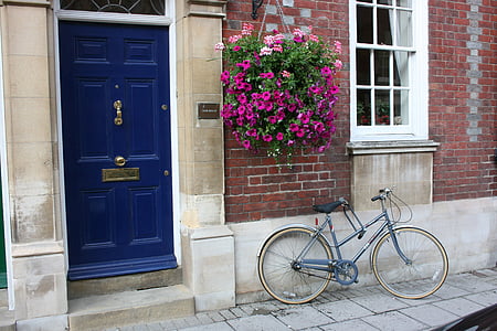 bicycle parked next to house with blue door ] thumbnail
