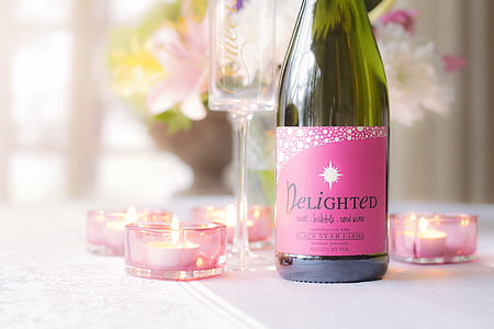Delighted liquor bottle beside tealight candles thumbnail