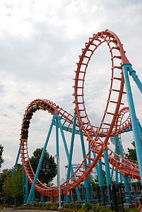photo of red and blue roller coaster during daytime thumbnail
